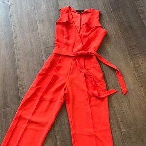 Red orange belted  jumpsuit with ruffle detailing